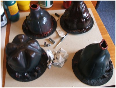 Once heated and warped, the bottle sections were glued to the CD bases and undercoated black